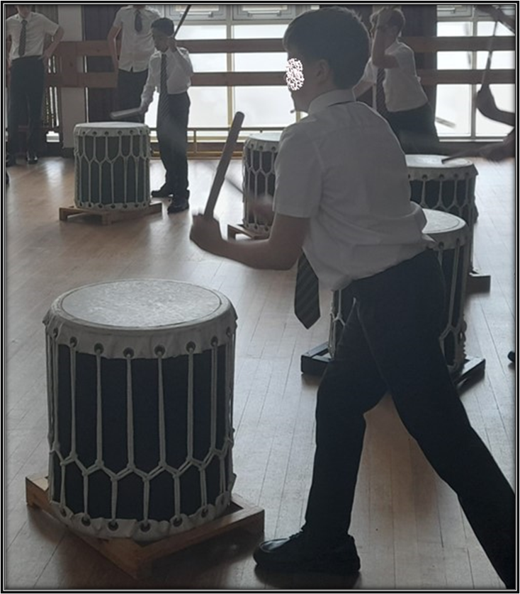 student playing on the taiko drums