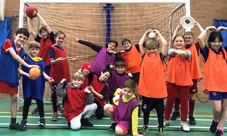 A photo of a group of children enjoying a holiday club event