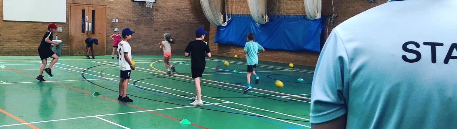A group of children taking part in an activity in the Sports Hall